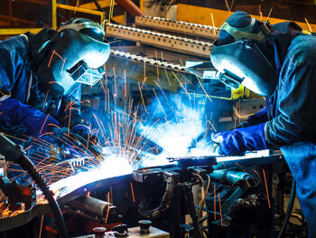 Two welders working on a custom fabrication project